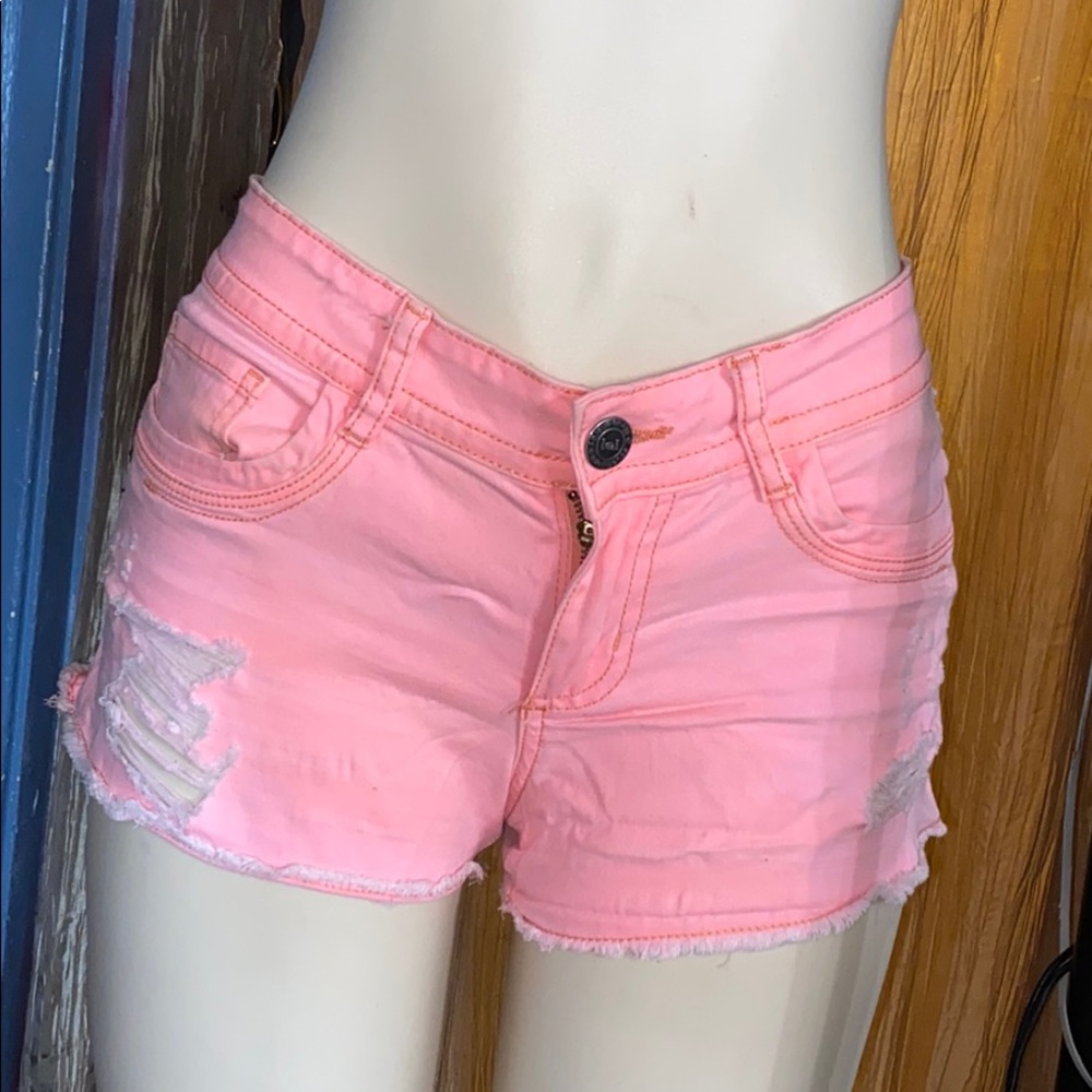 ripped light pink shorts